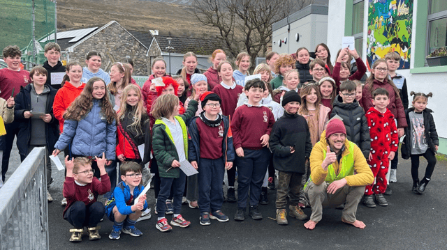 Eamonn Keaveney pictured with pupils at Murrisk School, Co. Mayo, on the final stretch of his barefoot journey