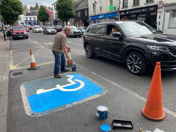 Mick Higgins painting a disabled parking space on Shop Street in Westport