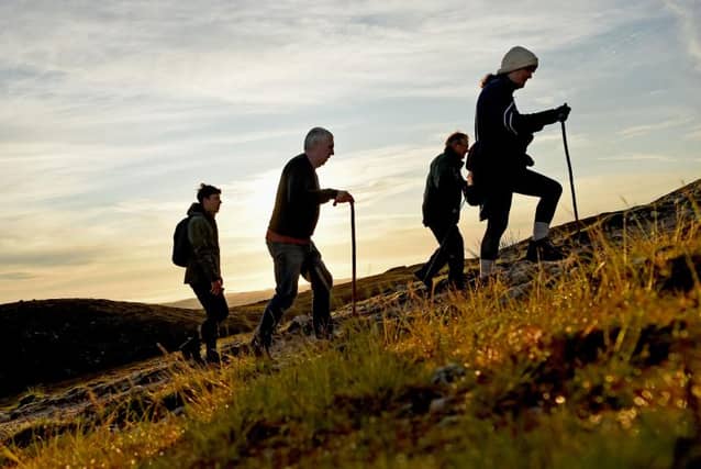 The sun rises behind pilgrims climbing Croagh Patrick for Reek Sunday 2024 (Pic: Conor McKeown)