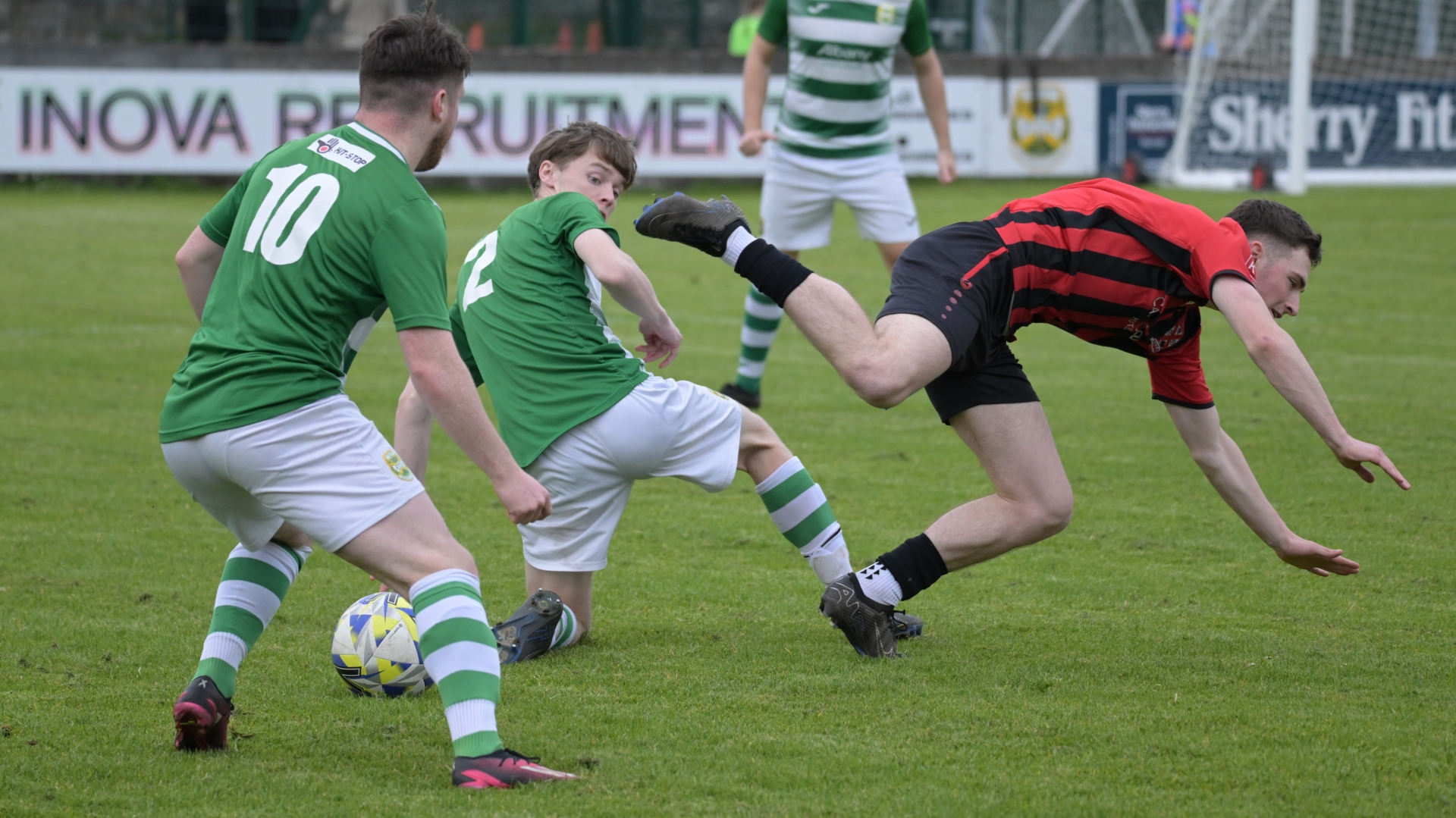 Westport United’s Cian Halpin flies over Celtic’s Mark Cunningham (2) with Jason Hunt (10) and Cathal Coyne watching (Pic: John Corless)