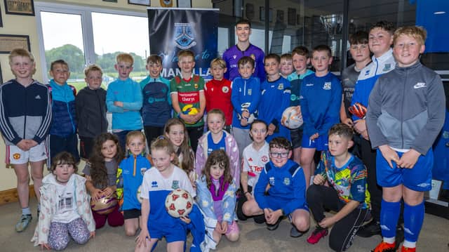 Wrexham goalkeeper Luke McNicholas met Manulla's stars of the future. Pic: Corless