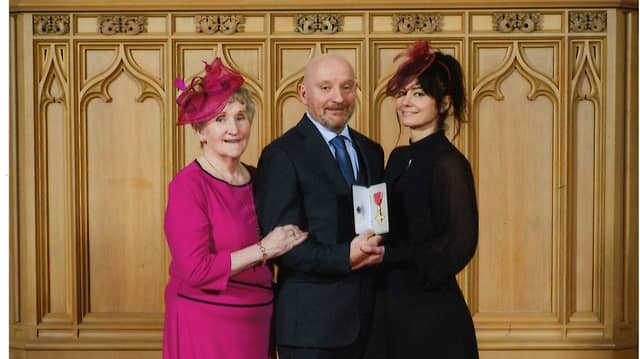Dr Martin Walsh pictured with his mother (left) Carmel Quinn after formally receiving his OBE from King Charles lll