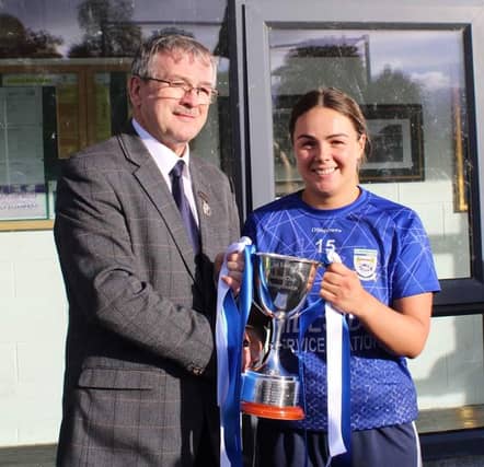 Claremorris captain Laura Kelly is pictured receiving the Connacht Ladies Junior club cup from President of Connacht LGFA, Con Moynihan.
