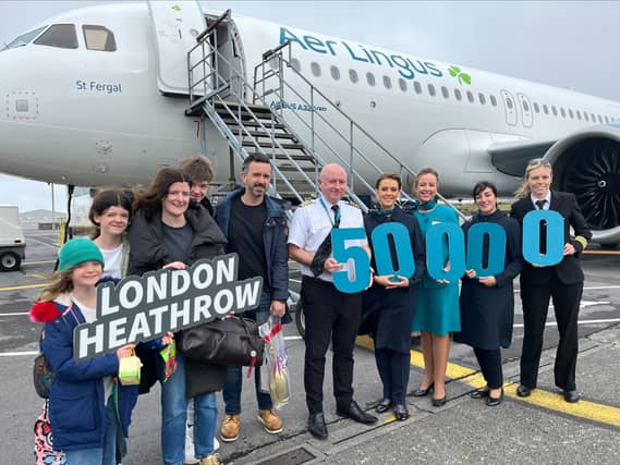 James Doyle, 50,000th passenger on the Knock/Heathrow service pictured with his wife Clare and three children. Also Pictured also are the Aer Lingus cabin crew and pilot.