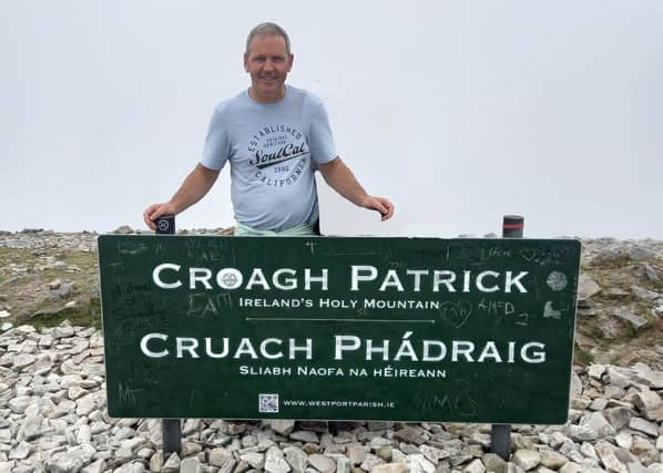 Cllr Ger Deere feels that graffiti has destroyed the sign on the summit of Croagh Patrick.