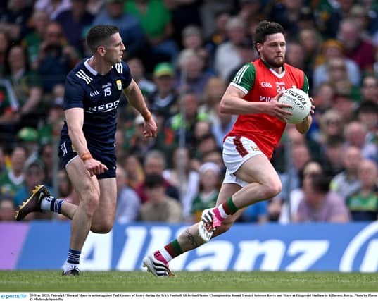 Mayo's Padraig O'Hora goes past Kerry's Paul Geaney