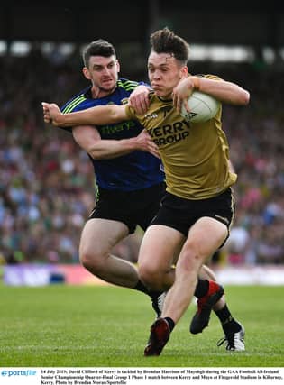 Kerry's David Clifford takes on Mayo's Brendan Harrison.