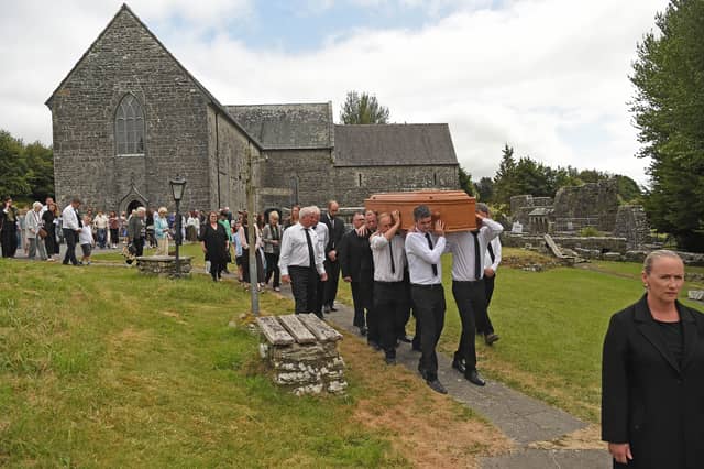 FINAL JOURNEY Members of the local community carry the remains of Fr Frank Fahey from Ballintubber Abbey to the adjoining cemetery after his Funeral Mass on Monday afternoon.