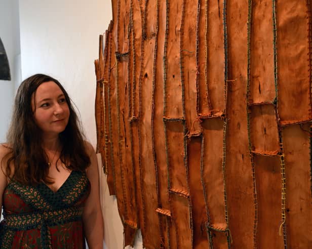 Australian-born, Mayo-based artist Christine Prescott beside her work, 'Find Something to Love'