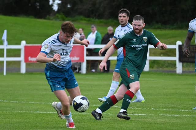 TU Dublin's Kian Reddy beats Mayo's Ben Edeh and Connor McCarthy in Saturday evening's FAI National League Match at Umbro Park.