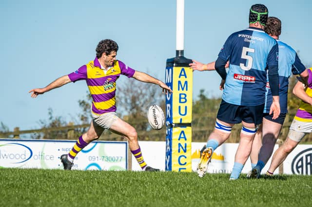 Ballyhaunis scrum-half Rowan Gouws kicking the ball against Castlebar.