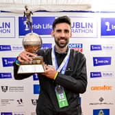 Men's National Champion Hugh Armstrong with the trophy after the 2026 Irish Life Dublin Marathon, as thousands of runners took to the streets of Dublin for the 45th running of the event. Pic: Sportsfile.