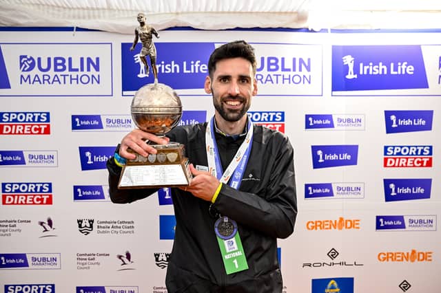 Men's National Champion Hugh Armstrong with the trophy after the 2026 Irish Life Dublin Marathon, as thousands of runners took to the streets of Dublin for the 45th running of the event. Pic: Sportsfile.