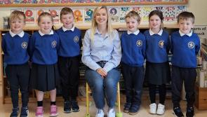 Teacher and new pupils all smiles on first day at school