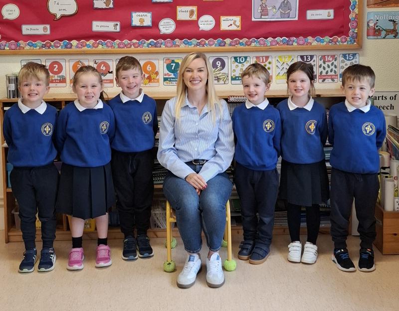 Teacher and new pupils all smiles on first day at school