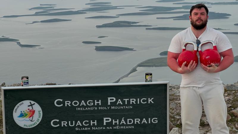 Man carrying two 32kg kettlebells climbs to the top of Mayo mountain